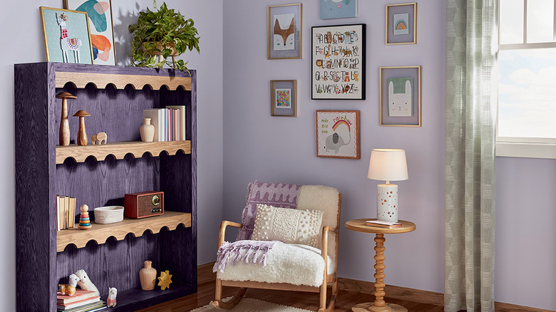 A kid's room with a purple stained bookcase