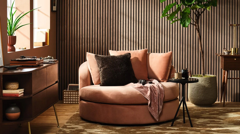 A room with a brown color scheme and a mocha mousse chair