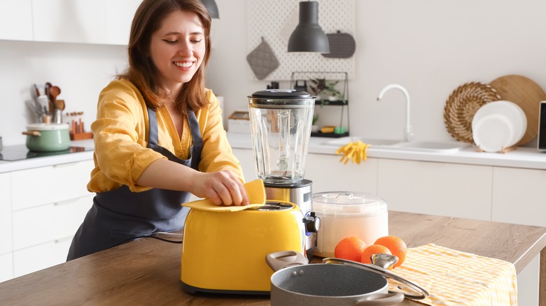 Person cleaning the toaster