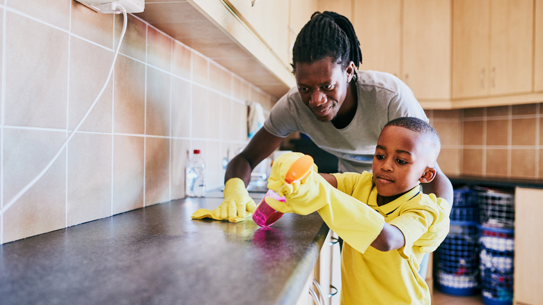 Man and son cleaning counters