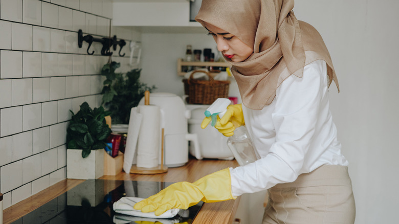 Woman cleaning stovetop