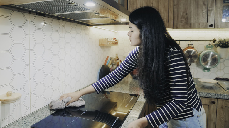 Woman cleaning stove