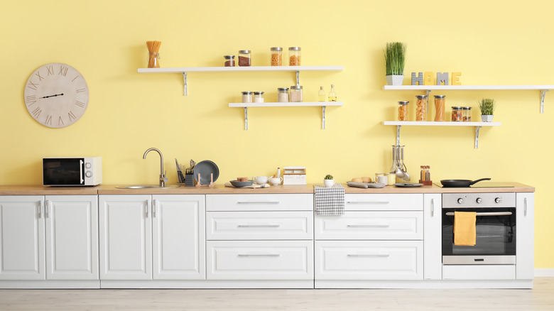 Yellow walls with white cabinets