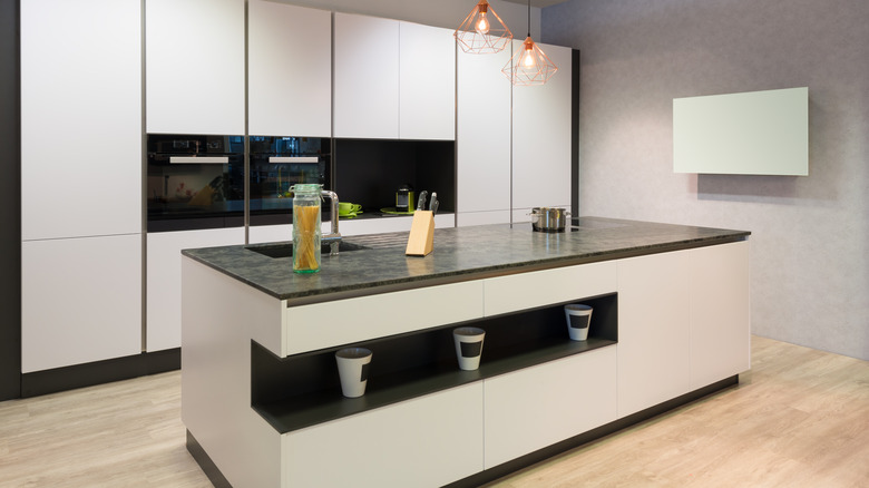 Minimalist kitchen with white slab cabinets and island