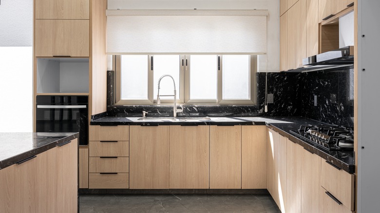 slab cabinet design in modern kitchen with light wood finish