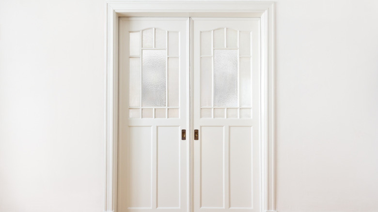 Double pocket doors installed in a white wall