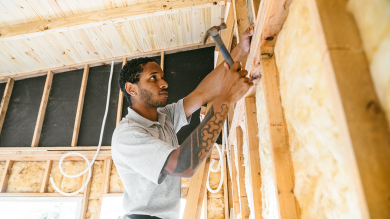 Man using hammer in shed