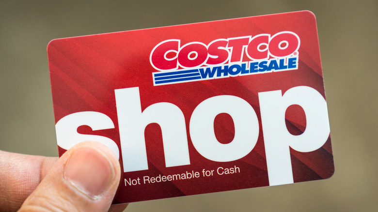 person holding costco cash card