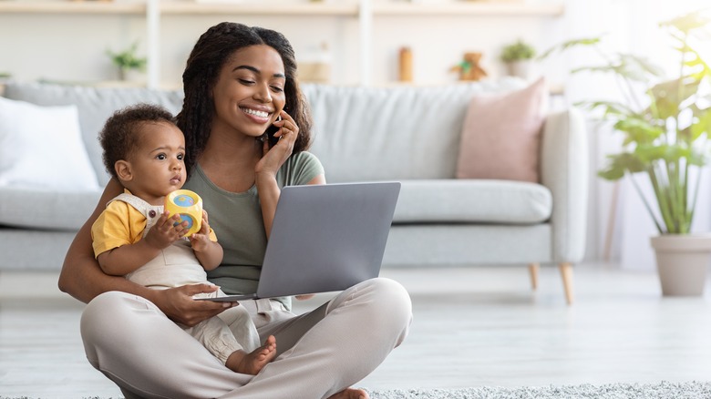 woman calling store holding baby