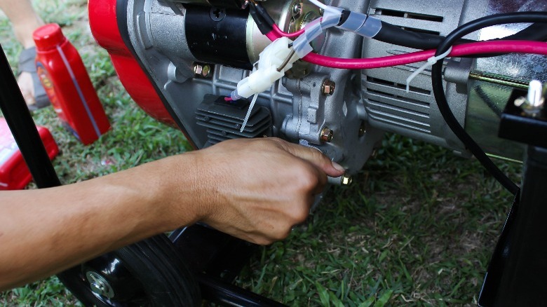 Closeup of portable generator, hand