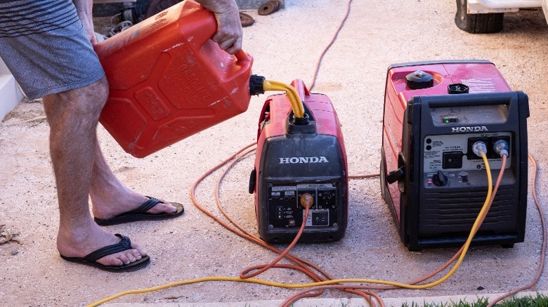 Man pouring fuel into portable generator