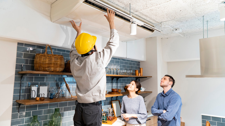 repairman working on ac unit