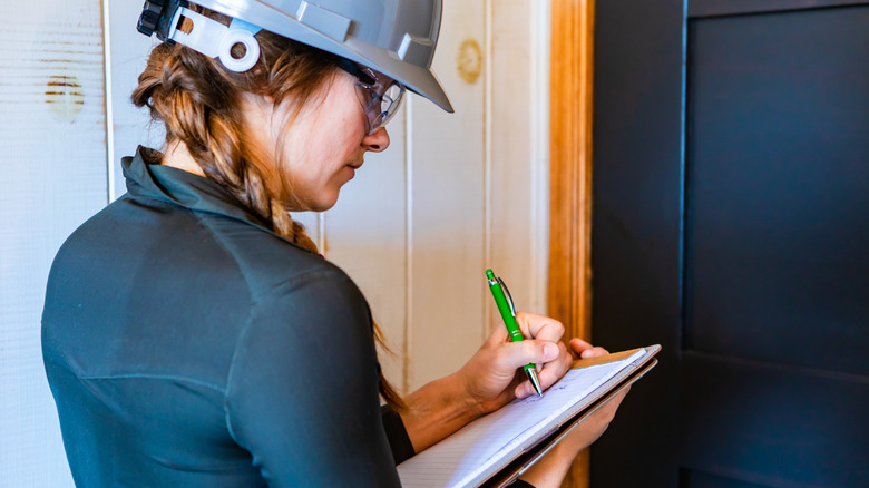 woman inspecting a home