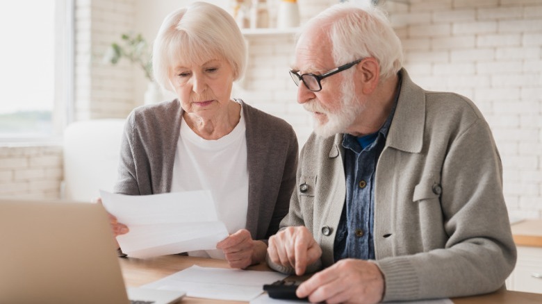 Senior couple looking over paperwork 