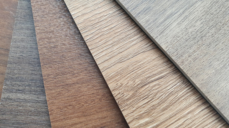 Different shades of vinyl plank flooring are shown.