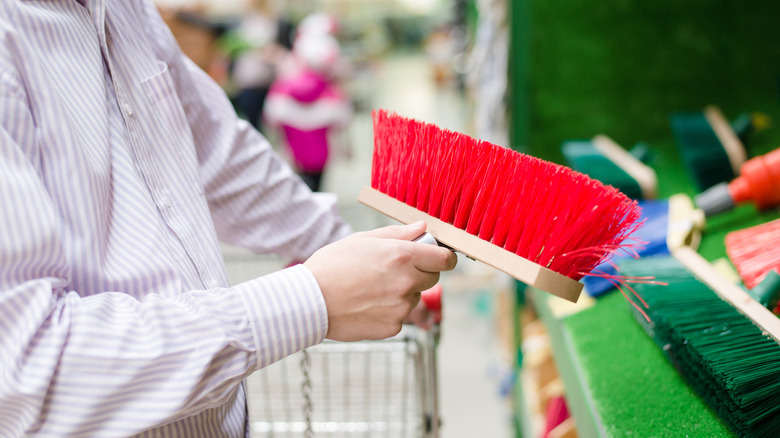 person shopping for a broom