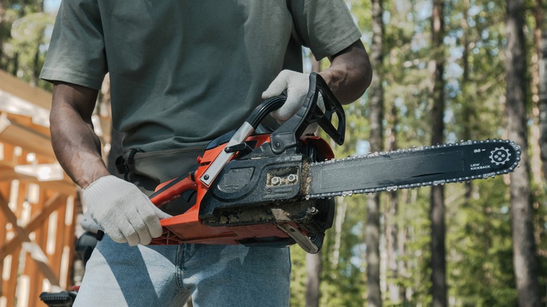 Man holding chainsaw