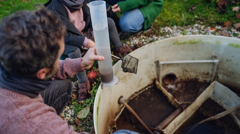 The family checks the water quality in the home wastewater treatment system