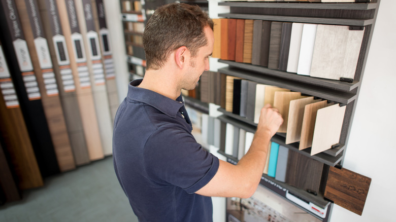 Person looking at wood samples