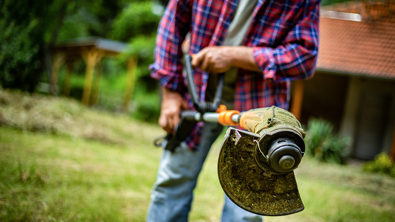 Person with grass trimmer