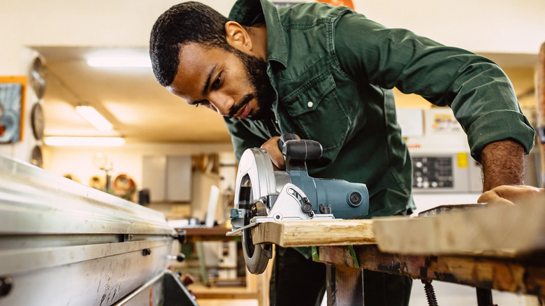 Person cutting wood