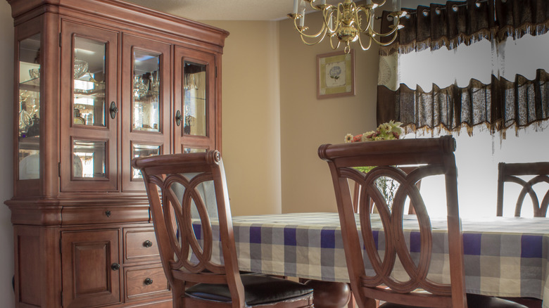 A dining room with a traditional standalone hutch.