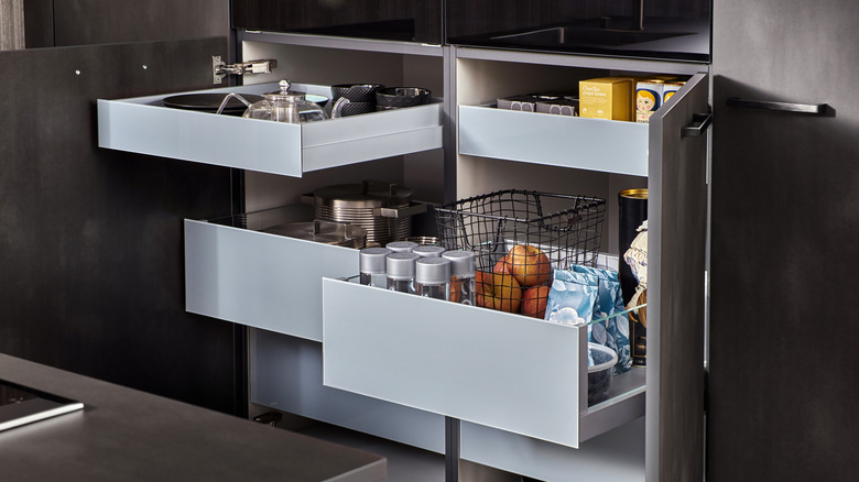 Storage drawers within kitchen cabinet