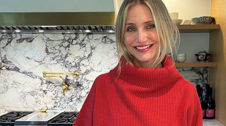 Cameron Diaz in front of marble backsplash