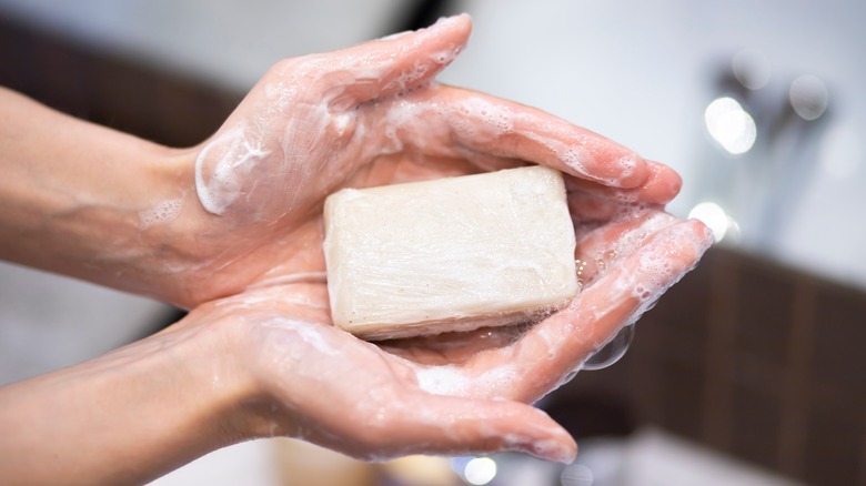 messy soap bar in hands