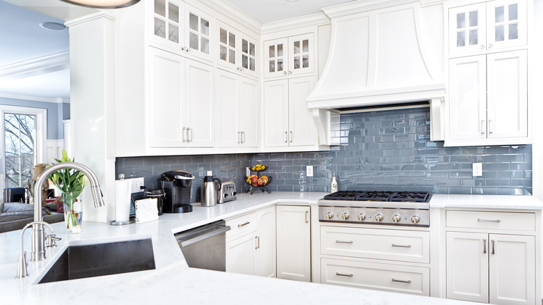 Bright white kitchen with blue-gray backsplash