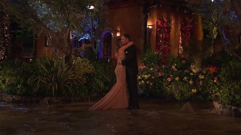 A couple on the Bachelor Mansion driveway