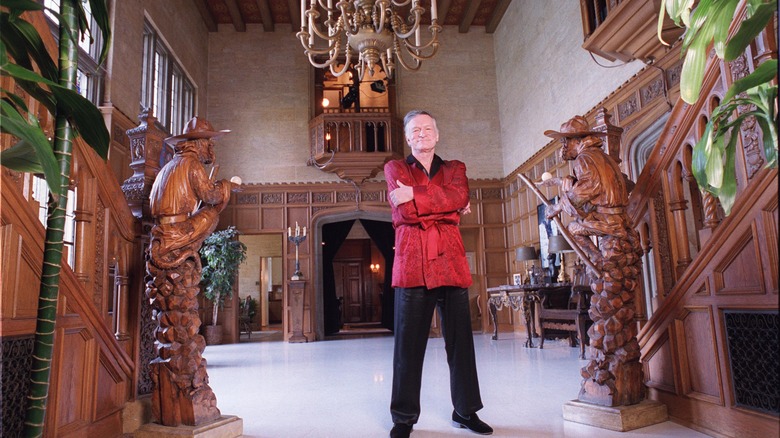 Hugh Hefner standing in Playboy mansion