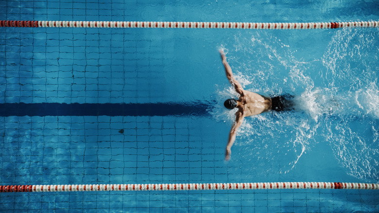 man swimming in pool