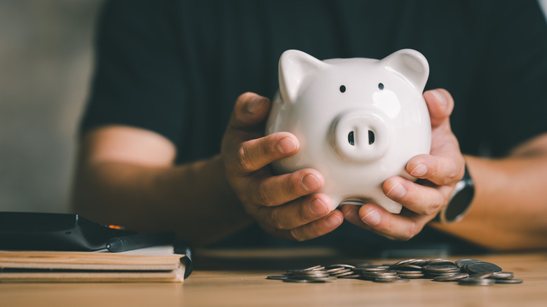 Man holding a piggy bank