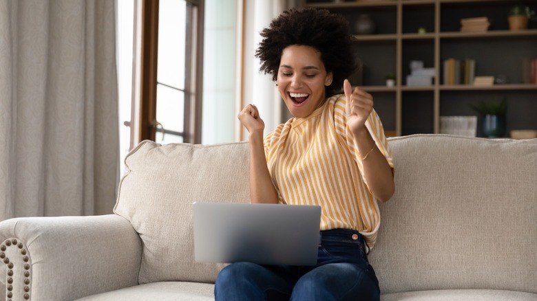 woman sitting on couch laptop