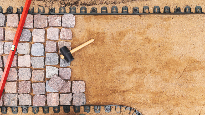 person building stone path