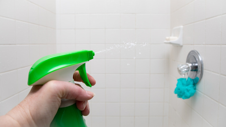 spraying water on shower tile