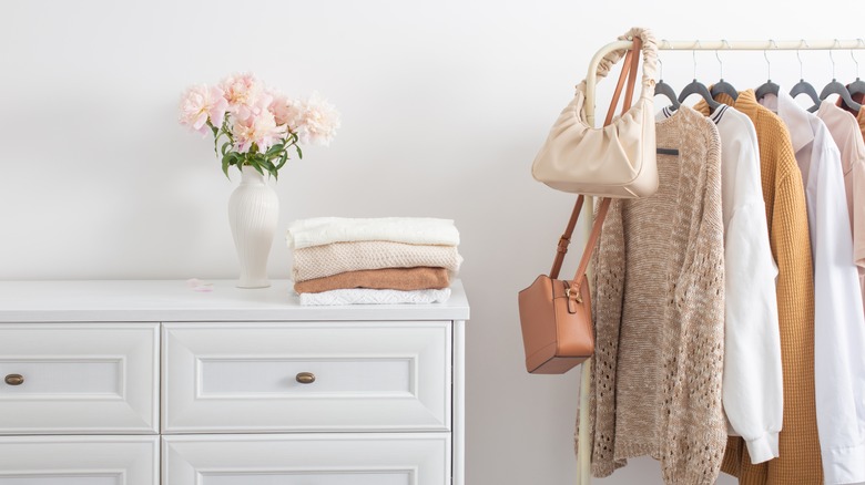 handbags hanging on clothing rail