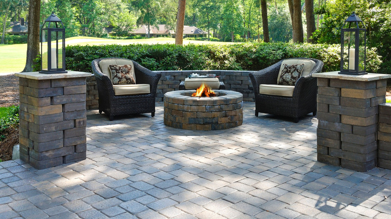 Attractive fire pit area using pavers for base, wall and pillars