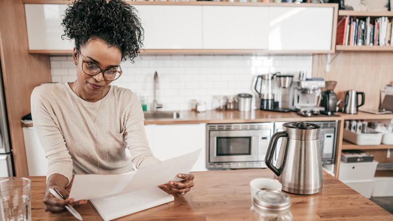 woman looking at bills