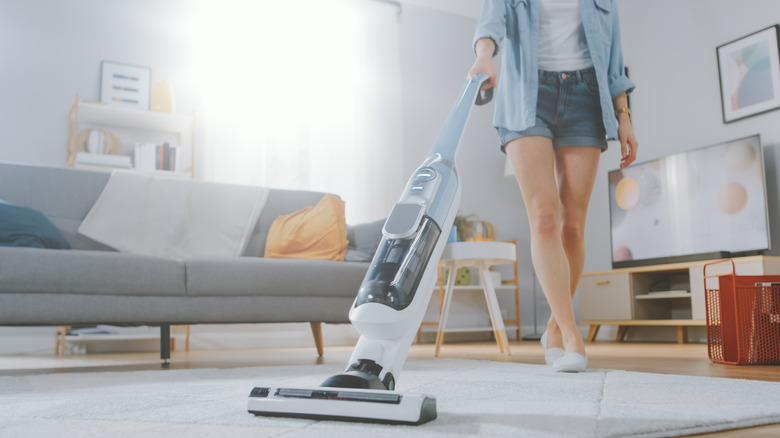 Person vacuuming carpet