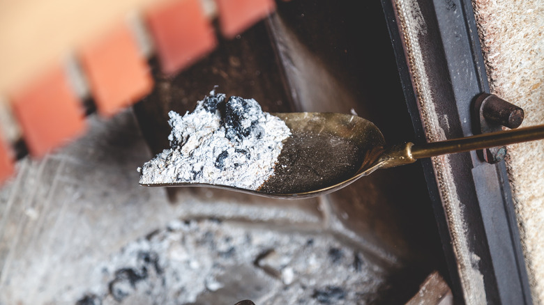 Cleaning fireplace with shovel