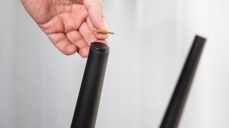 Person repairing table leg