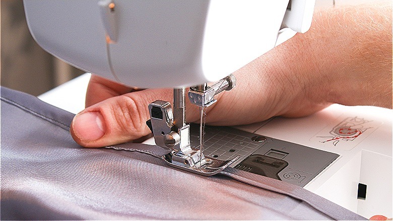 Person sewing a curtain