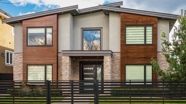 Modern stone house with fence