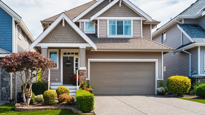 Tan house with white trim