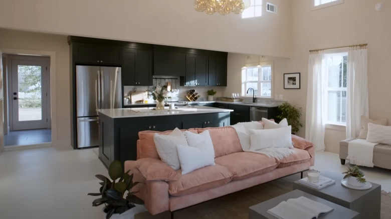 pink sofa and dark kitchen