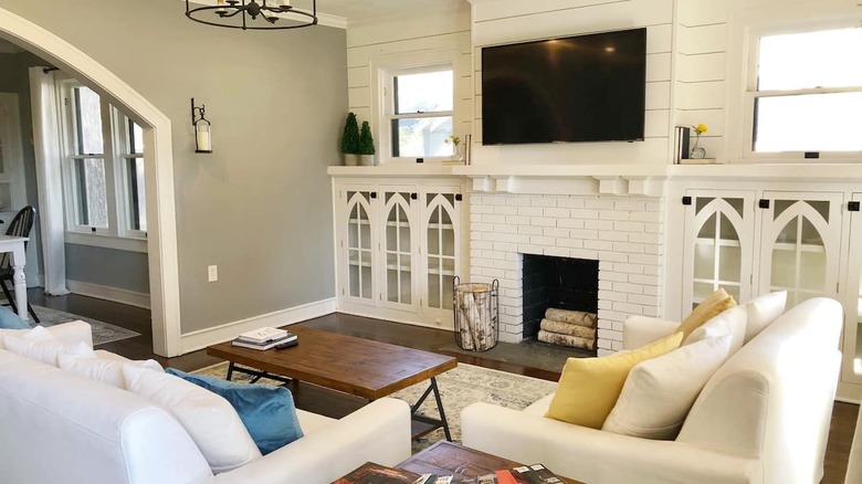 white brick fireplace and tv 