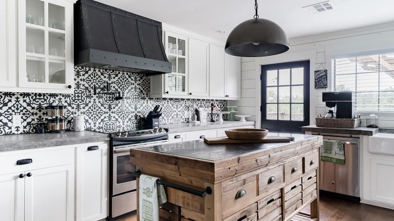 Tiled kitchen with white cabinets 