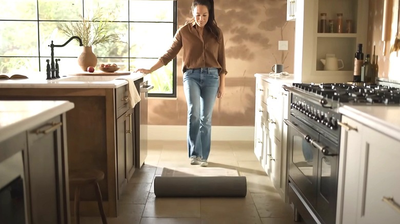 Joanna Gaines unrolling rug